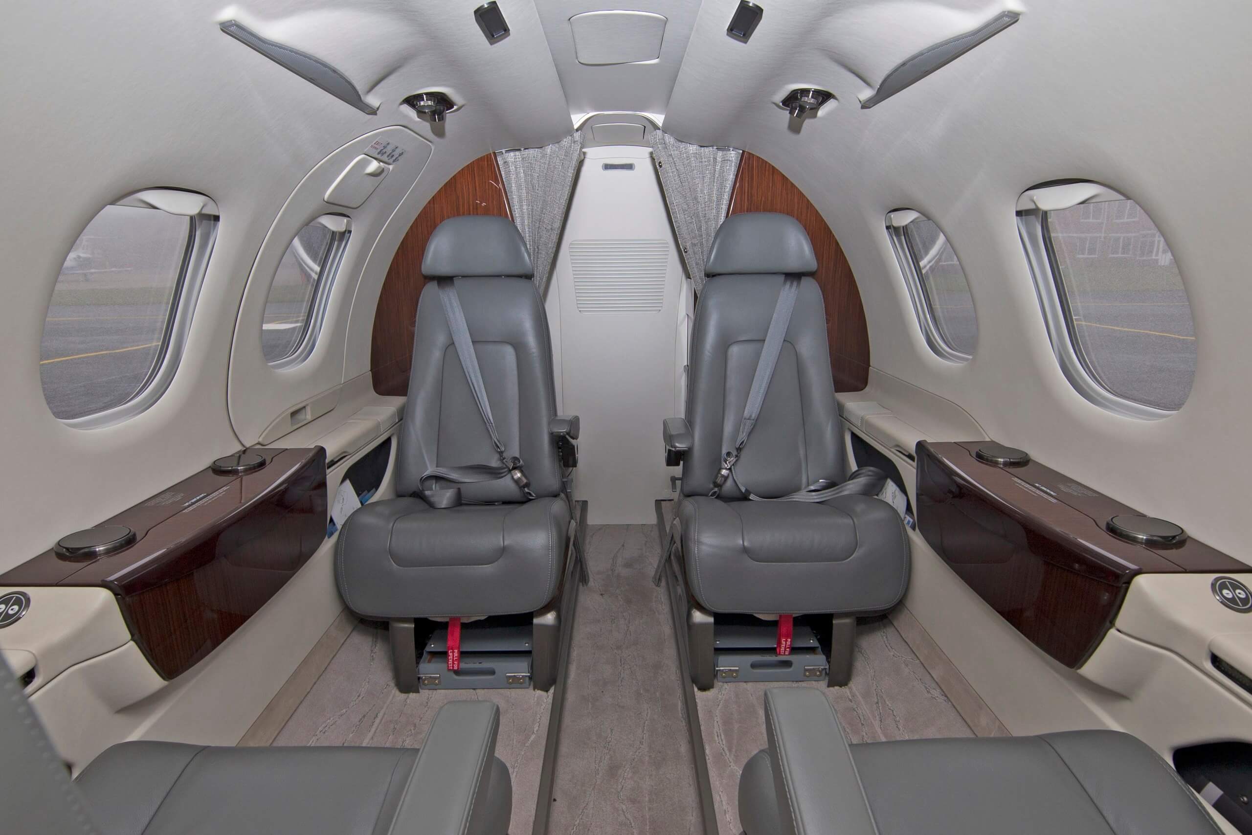 RAF Embraer Phenom 100 cabin with passenger seats and side windows
