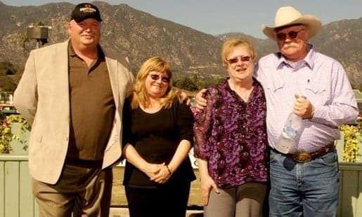 Four people posing together in the California Chrome archive article