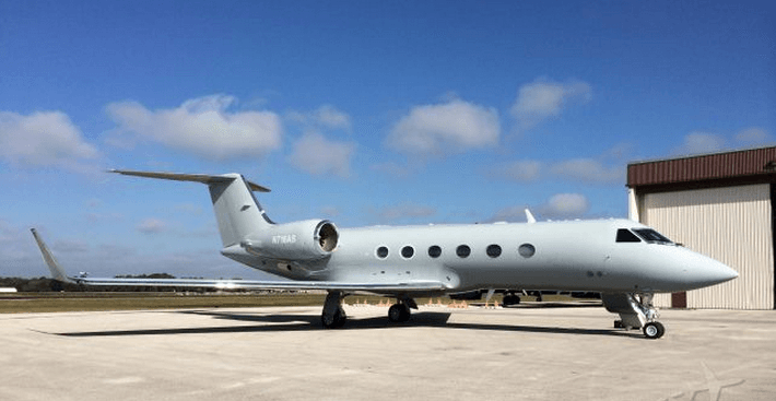 Gulfstream IV parked beside a hangar in the 2014 archive