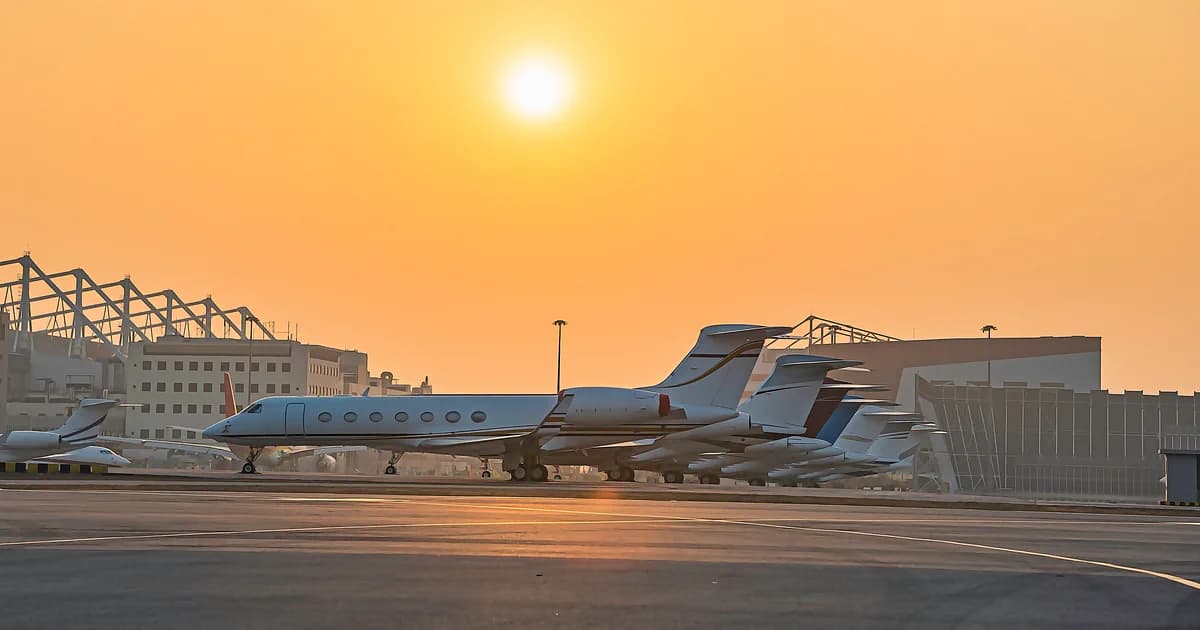 Business jets parked on an airport ramp
